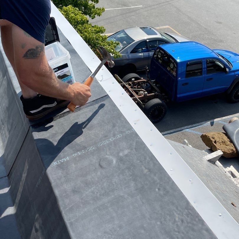 A person is fixing a roof with a drill