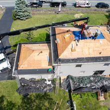 An aerial view of a roof that is being repaired