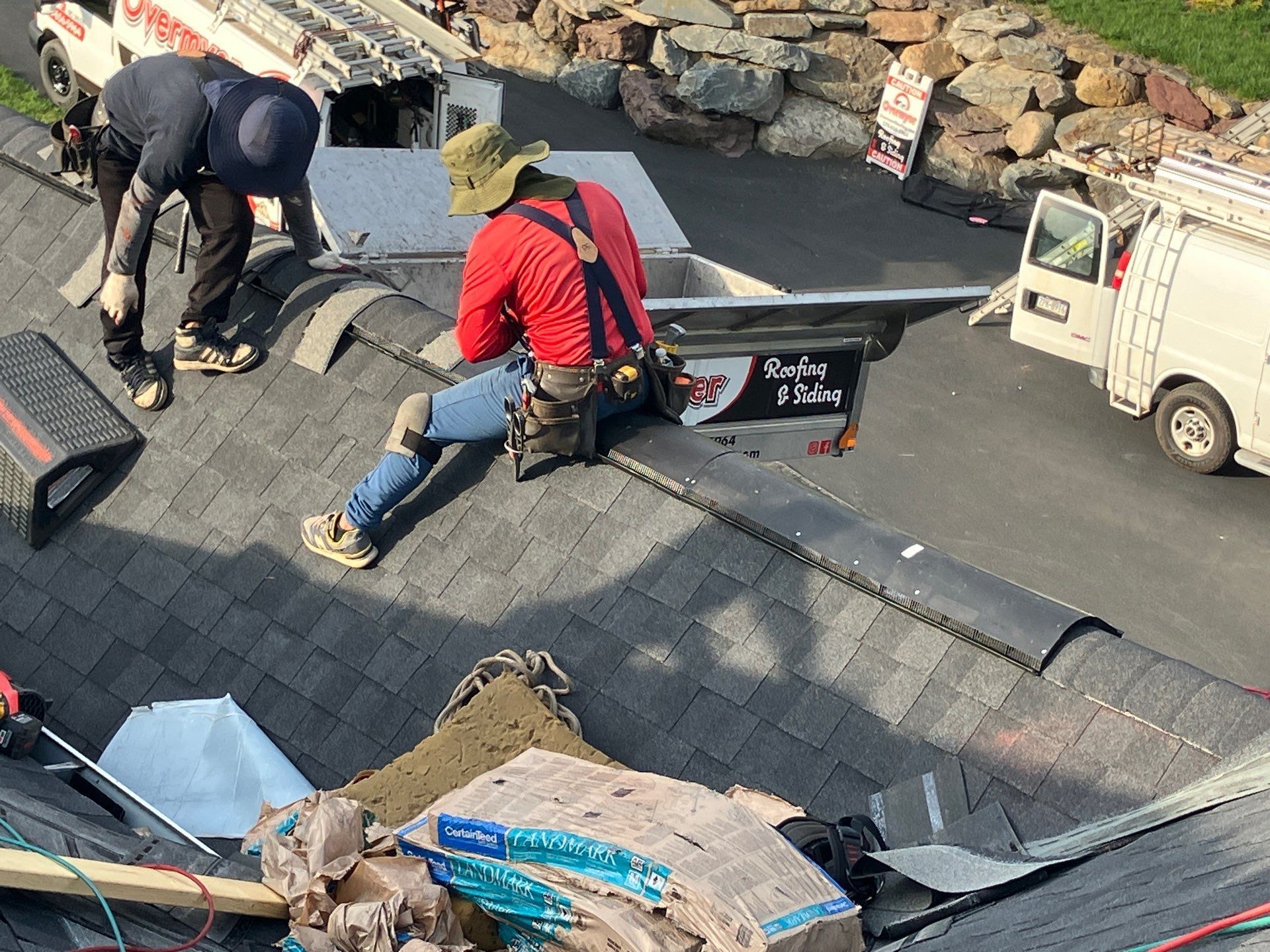 A close up of a gutter on the side of a house