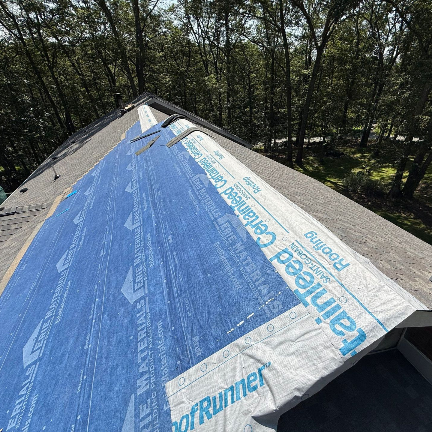 A person is fixing a roof with a drill A person is fixing a roof with a drill
