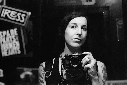 A woman is taking a picture of herself in a mirror.