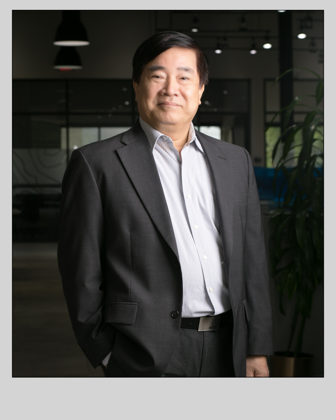 A man in a suit is standing with his hands in his pockets