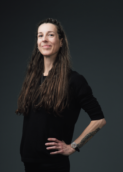 Photographer Madison Avery Somerville stands with her hand on her hip, smiling for the camera.