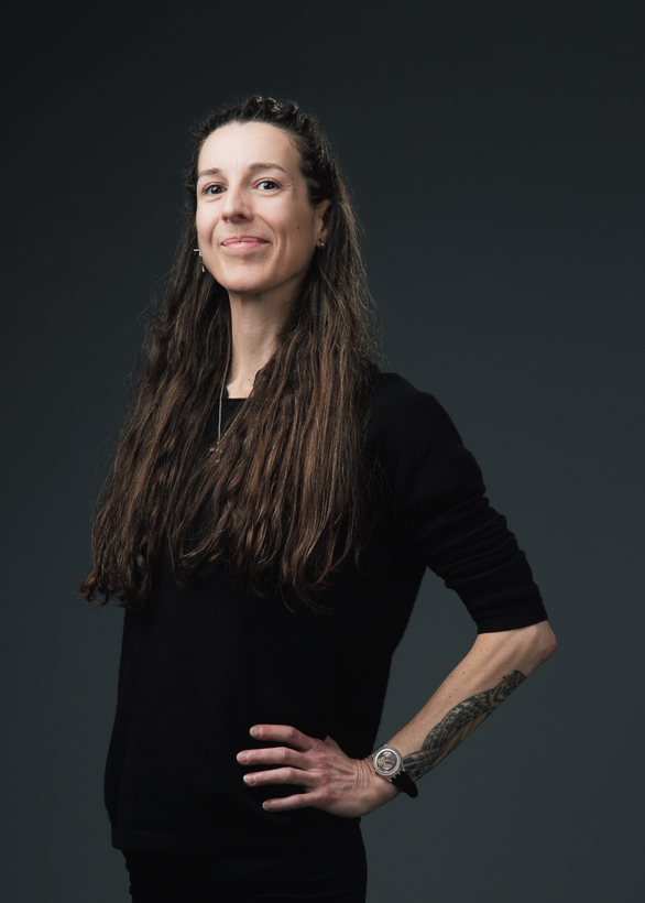 Photographer Madison Avery Somerville stands with her hand on her hip, smiling for the camera.