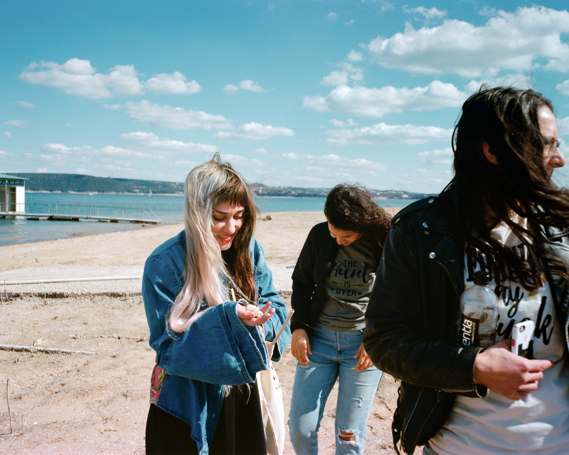 A group of young women are walking on a beach.