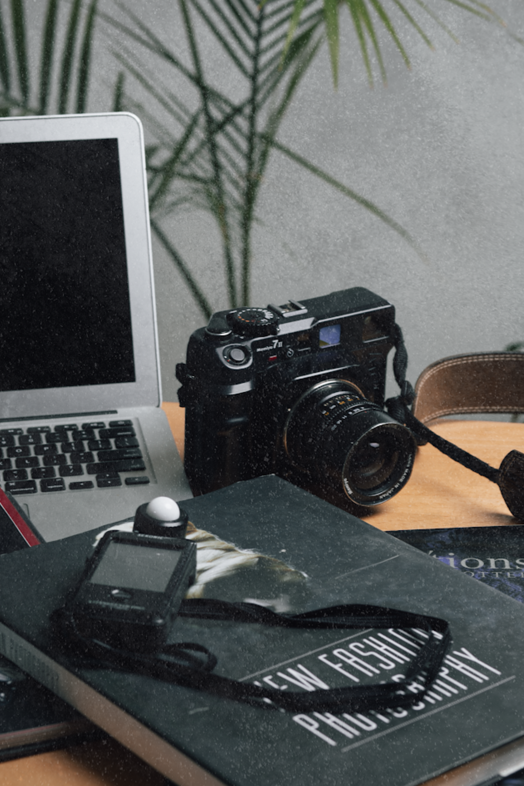 A camera is sitting on top of a book that says photography