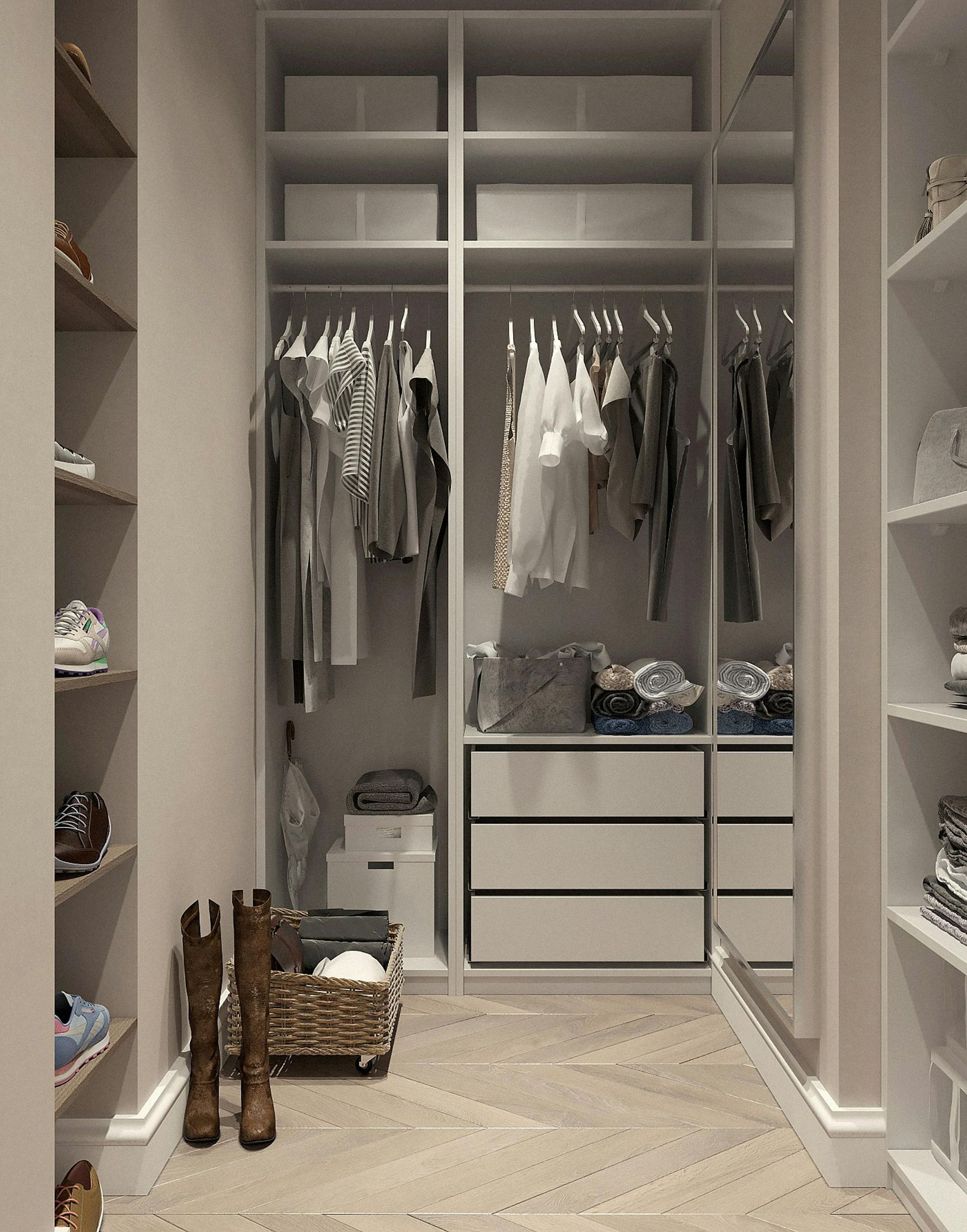 Walk-in closet with shelves and hanging clothes. Beige and white tones, wooden floors, shoes and boots.