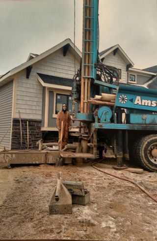 Man Standing Beside a Drilling Truck — Northeast, IN — Amstutz Well Drilling