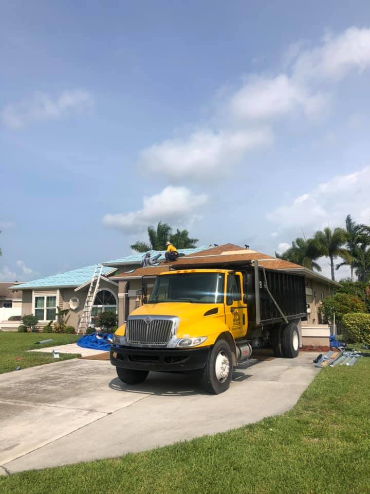 Black And Yellow Truck Outside — Naples, FL — SWF Roofing Inc.