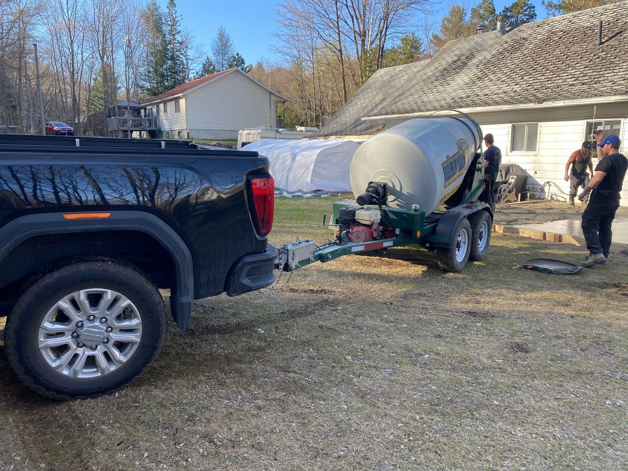 Un camion remorque une bétonnière sur une remorque.