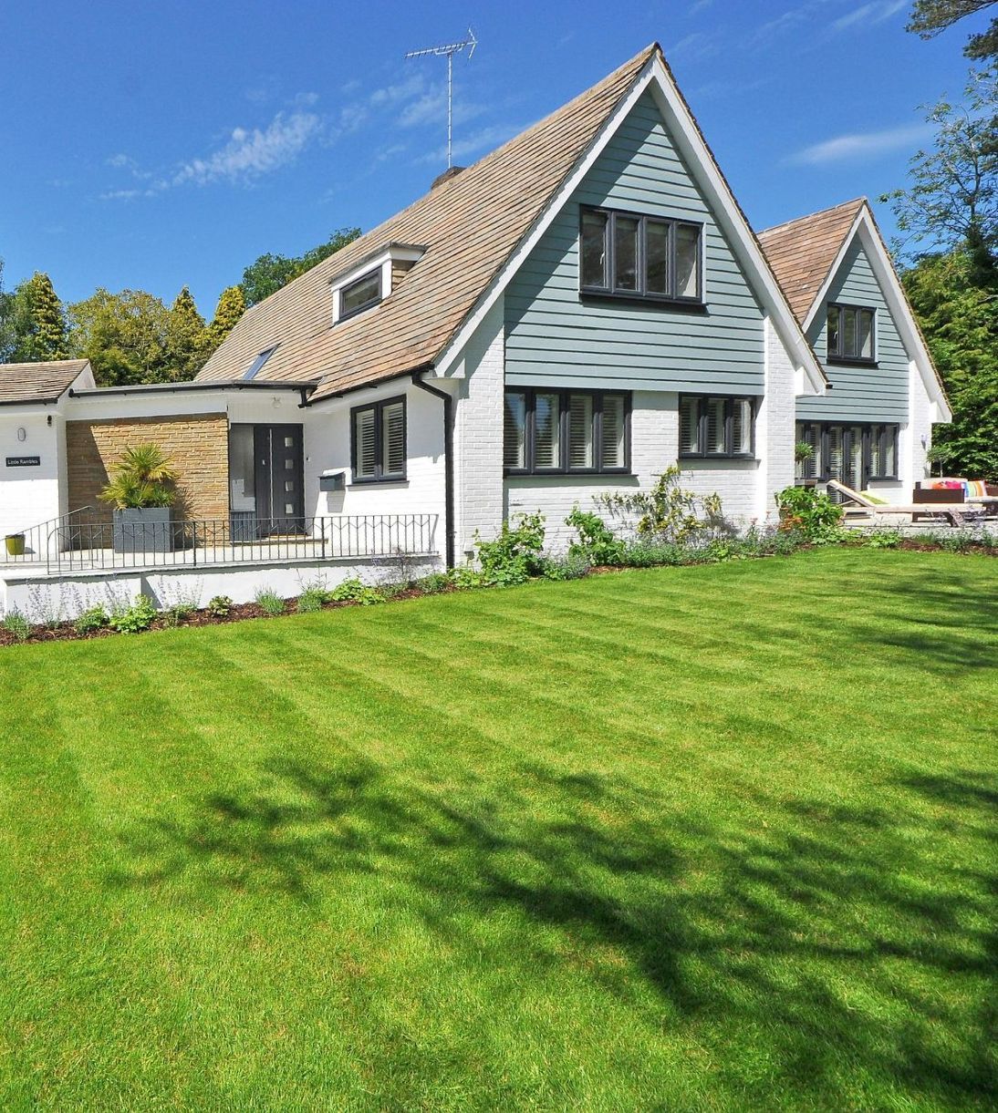 A large house with a lush green lawn in front of it