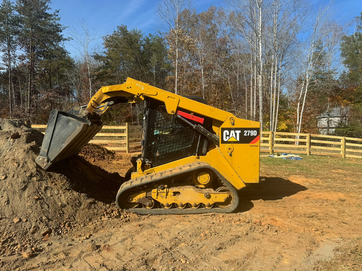 A bulldozer is moving a pile of bricks on a construction site.