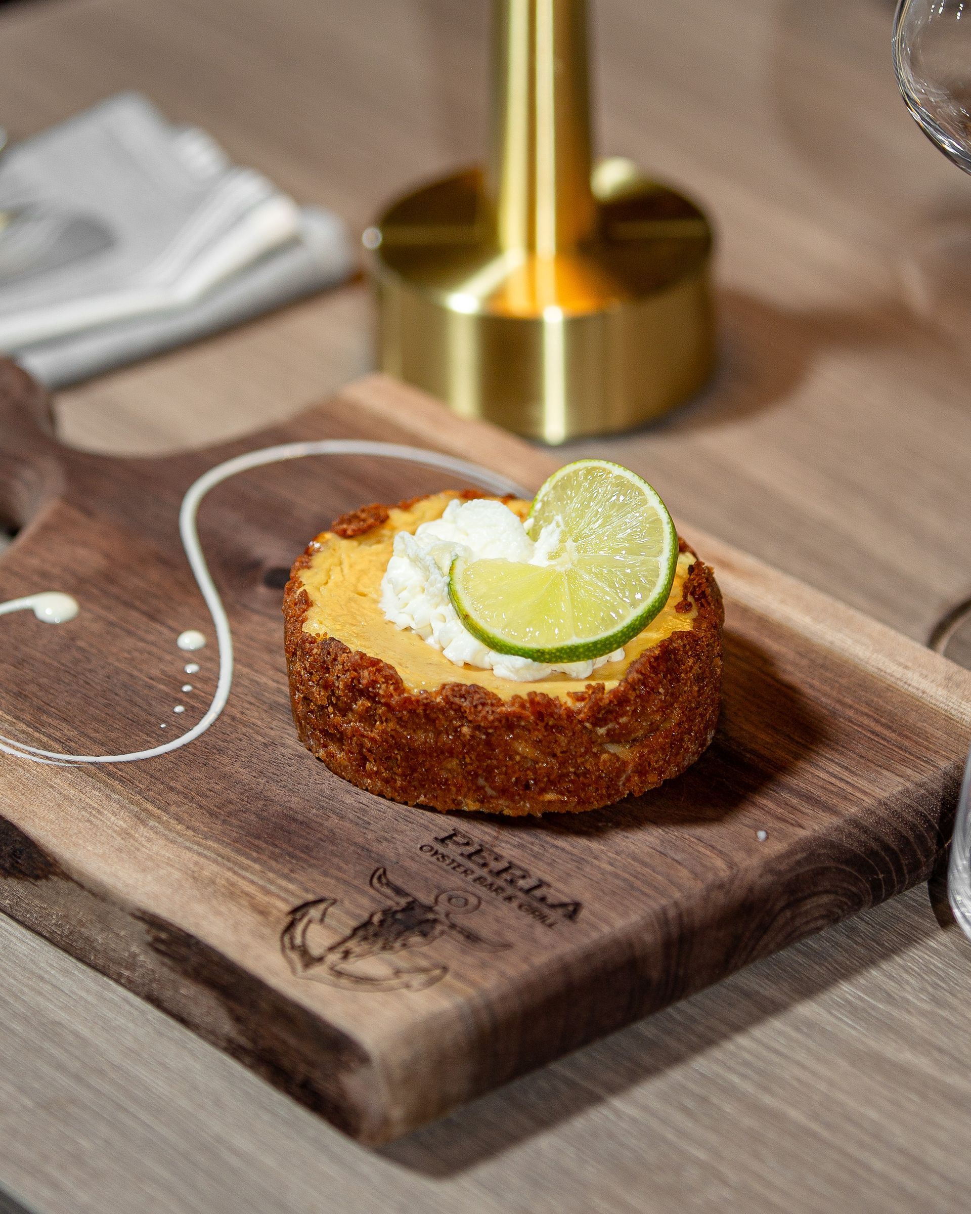 A close up of a piece of food on a wooden cutting board.