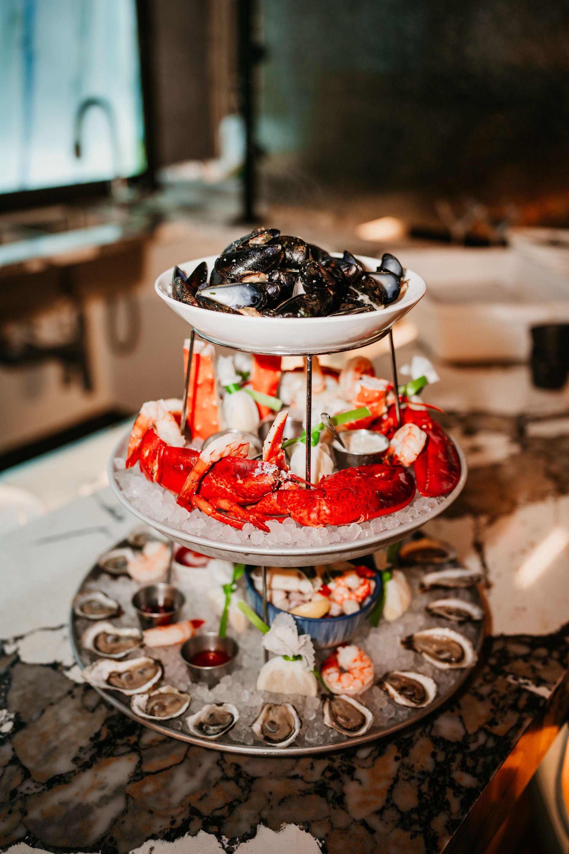 A stack of seafood on ice on a table.