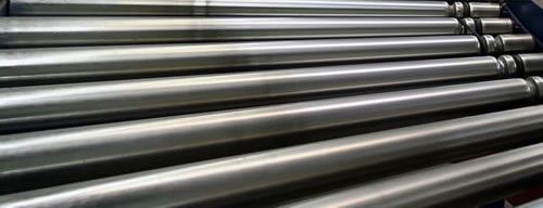 A close up of a bunch of metal pipes stacked on top of each other.