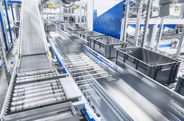A conveyor belt filled with boxes in a factory.