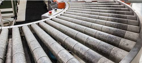 A conveyor belt with a lot of tubes on it.
