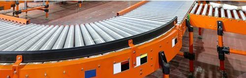 A conveyor belt is moving along a warehouse floor.