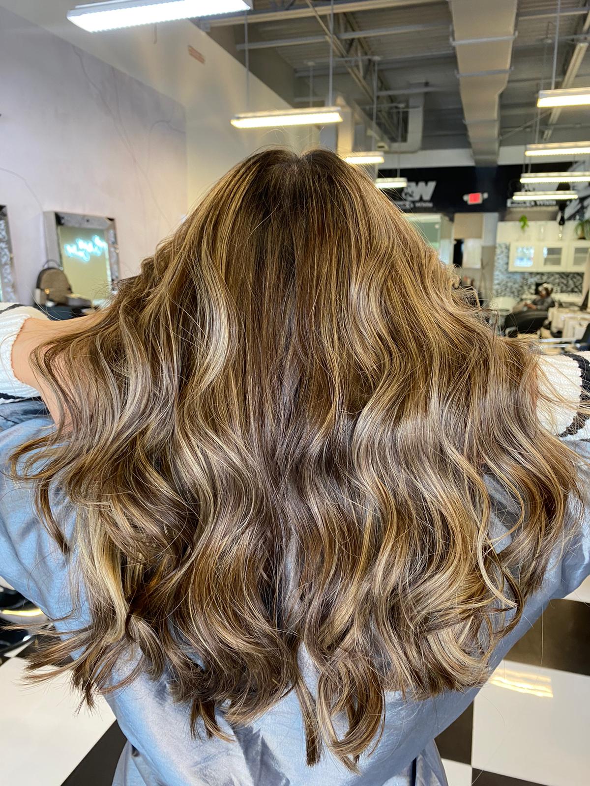 A woman is getting her hair done in a salon.