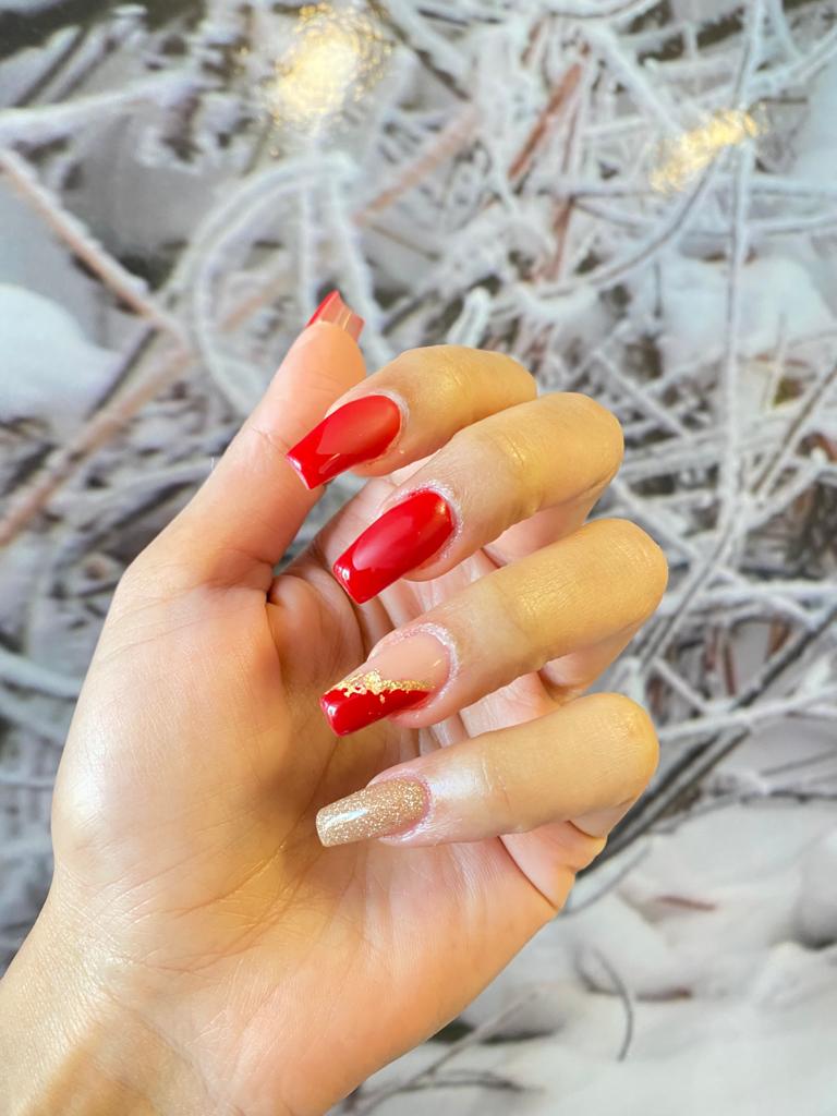 A close up of a person 's hand with red nails.