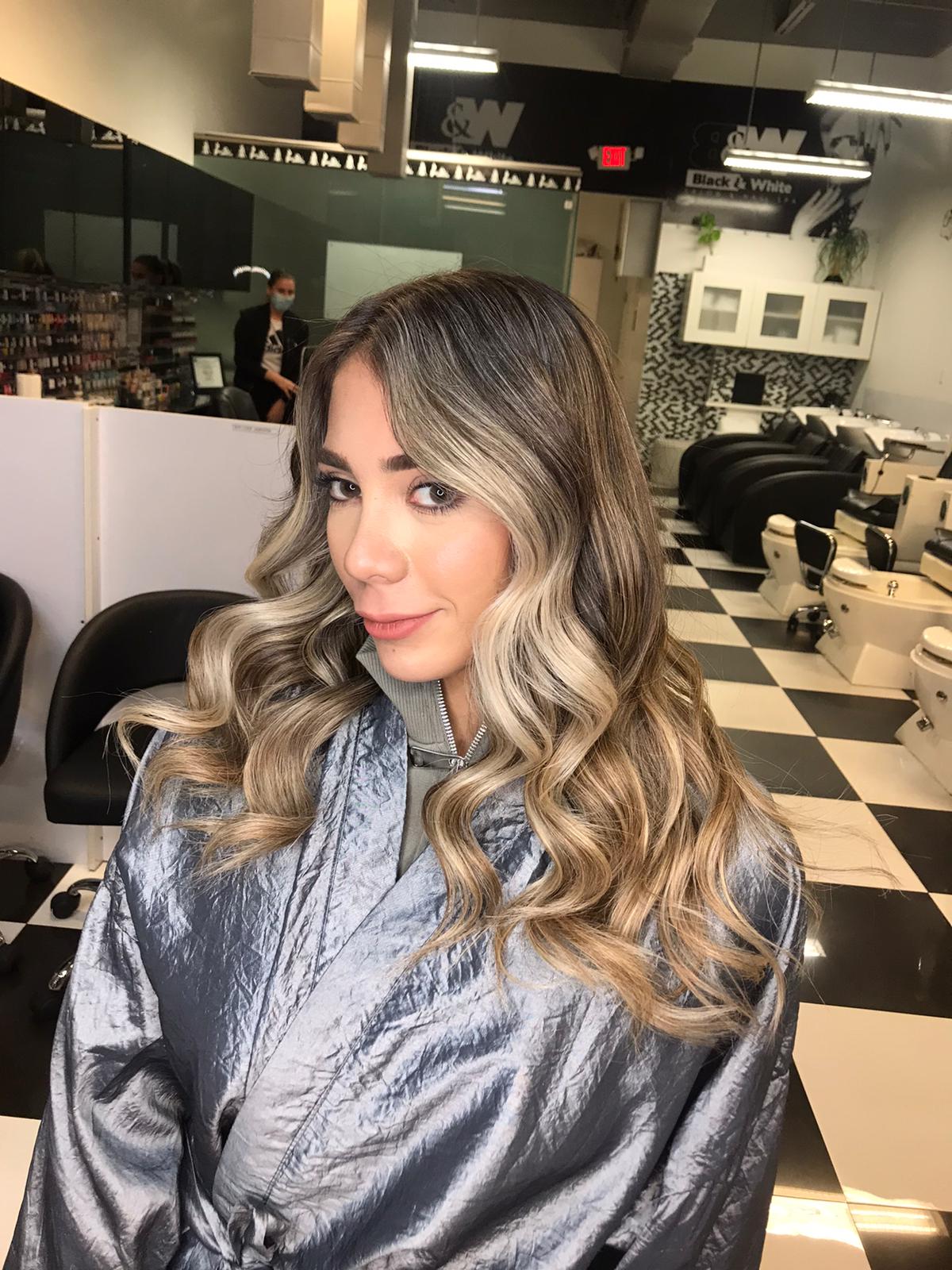A woman is getting her hair done in a salon.