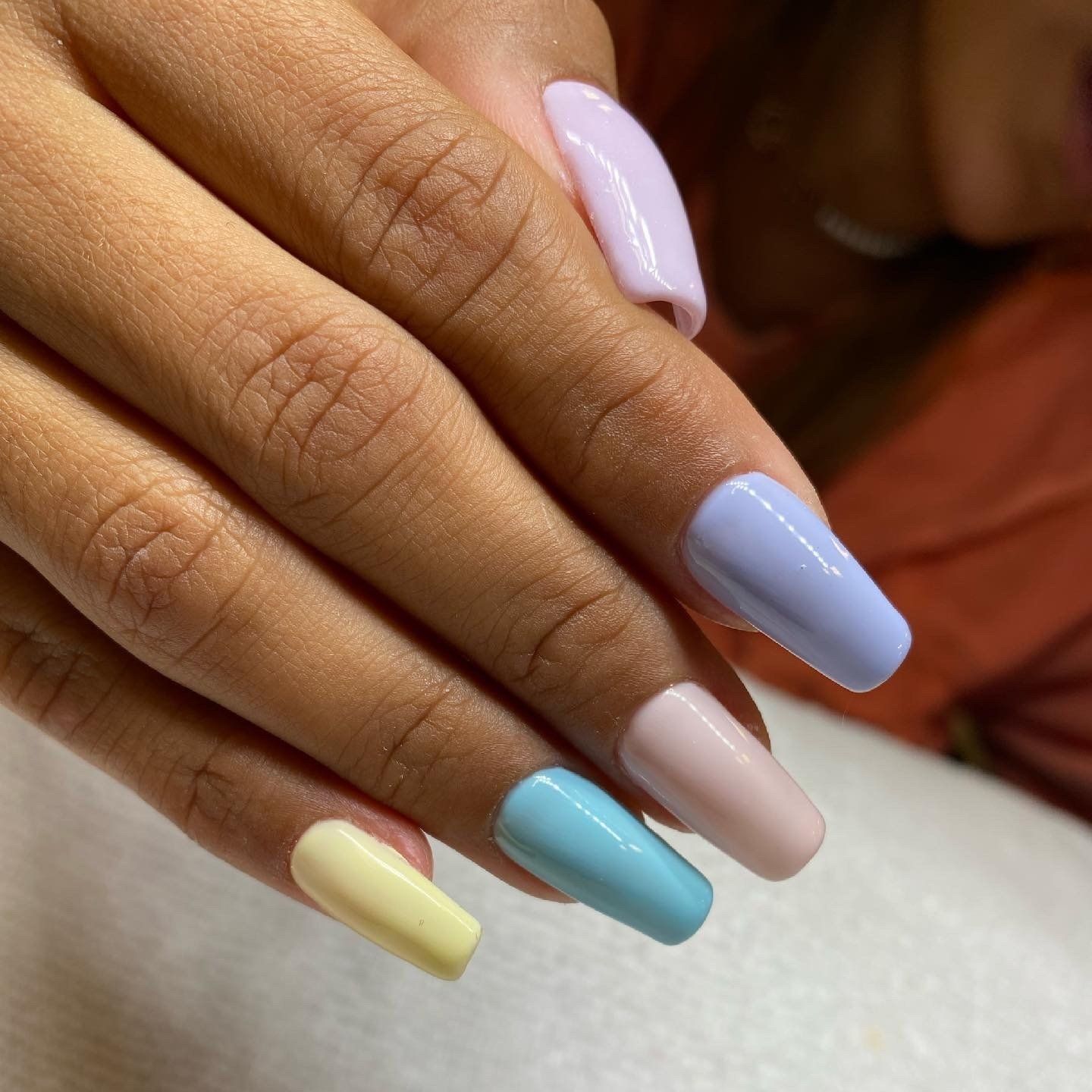 A close up of a woman 's nails with different colors