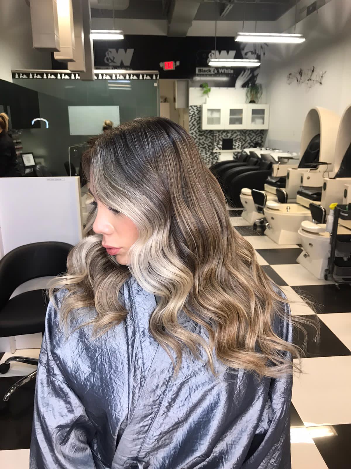 A woman is getting her hair dyed in a salon.