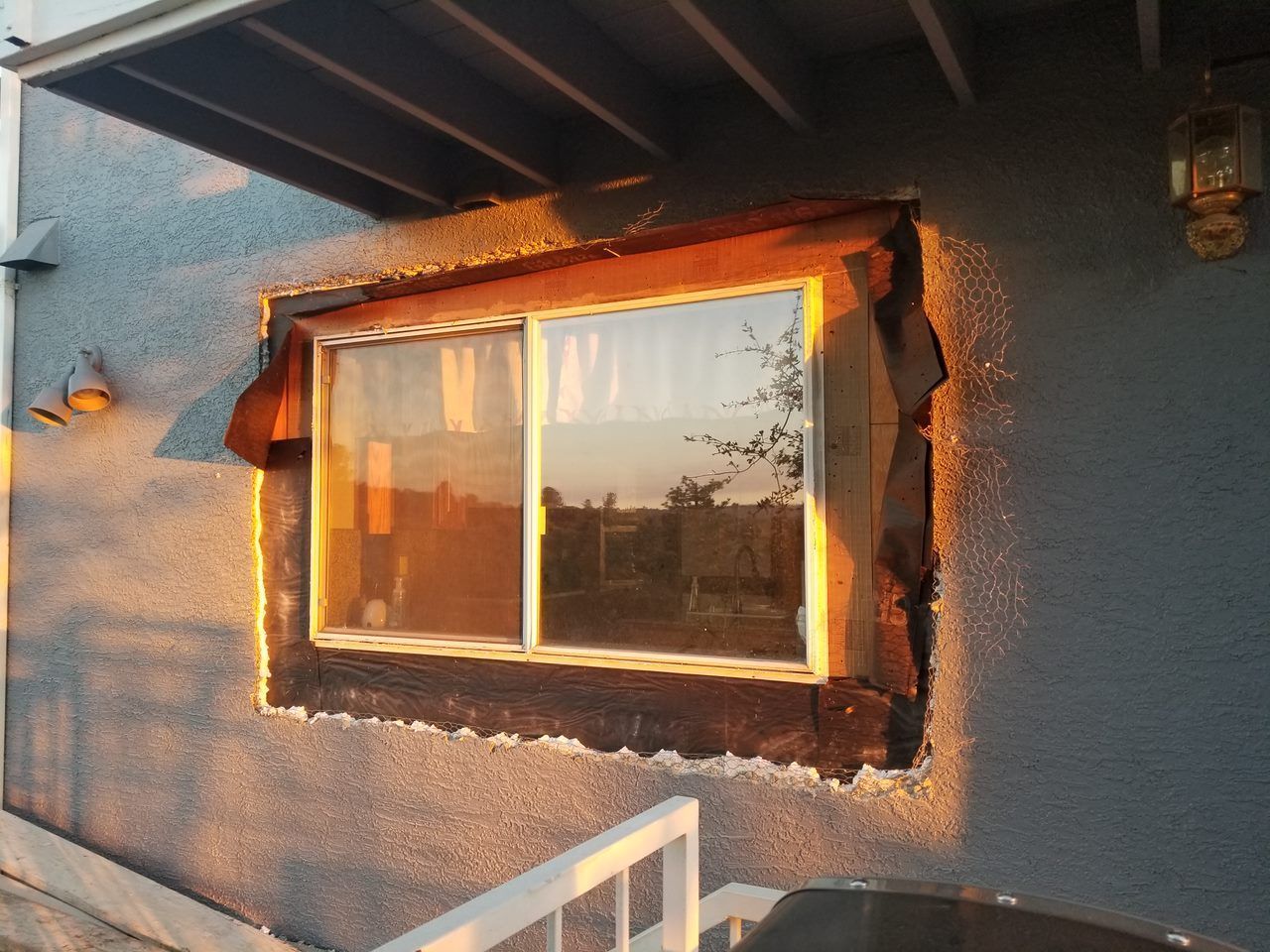 A window is being installed on the side of a building