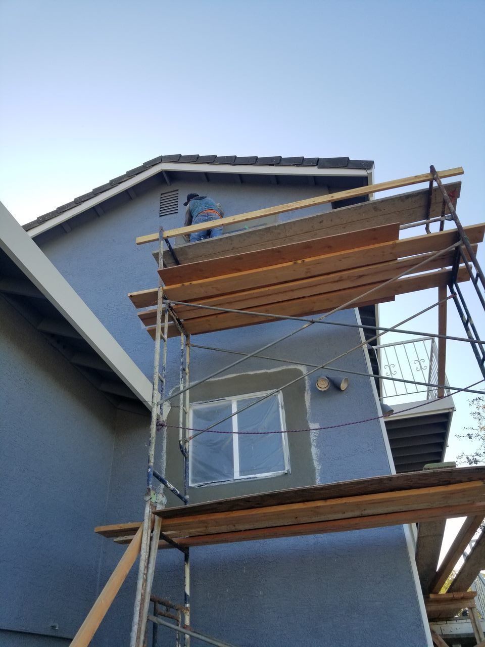 A blue building with scaffolding on the side of it