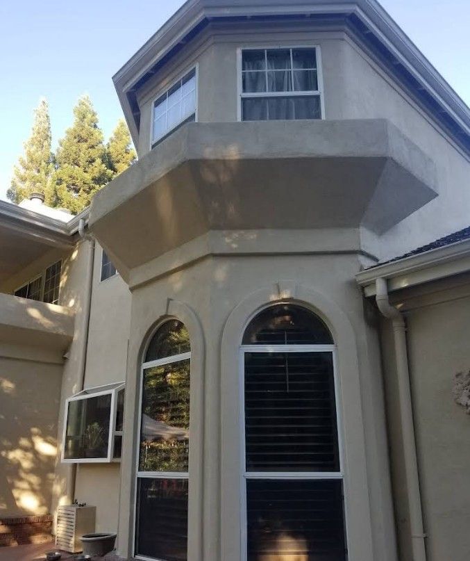 A house with a balcony and arched windows