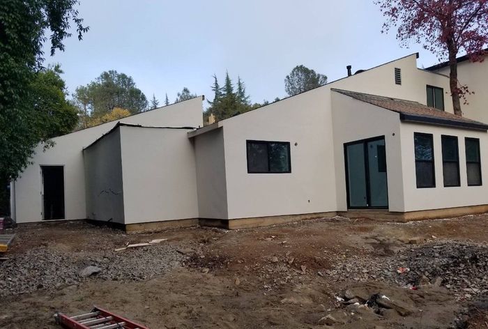 A large white house with a lot of windows is being built