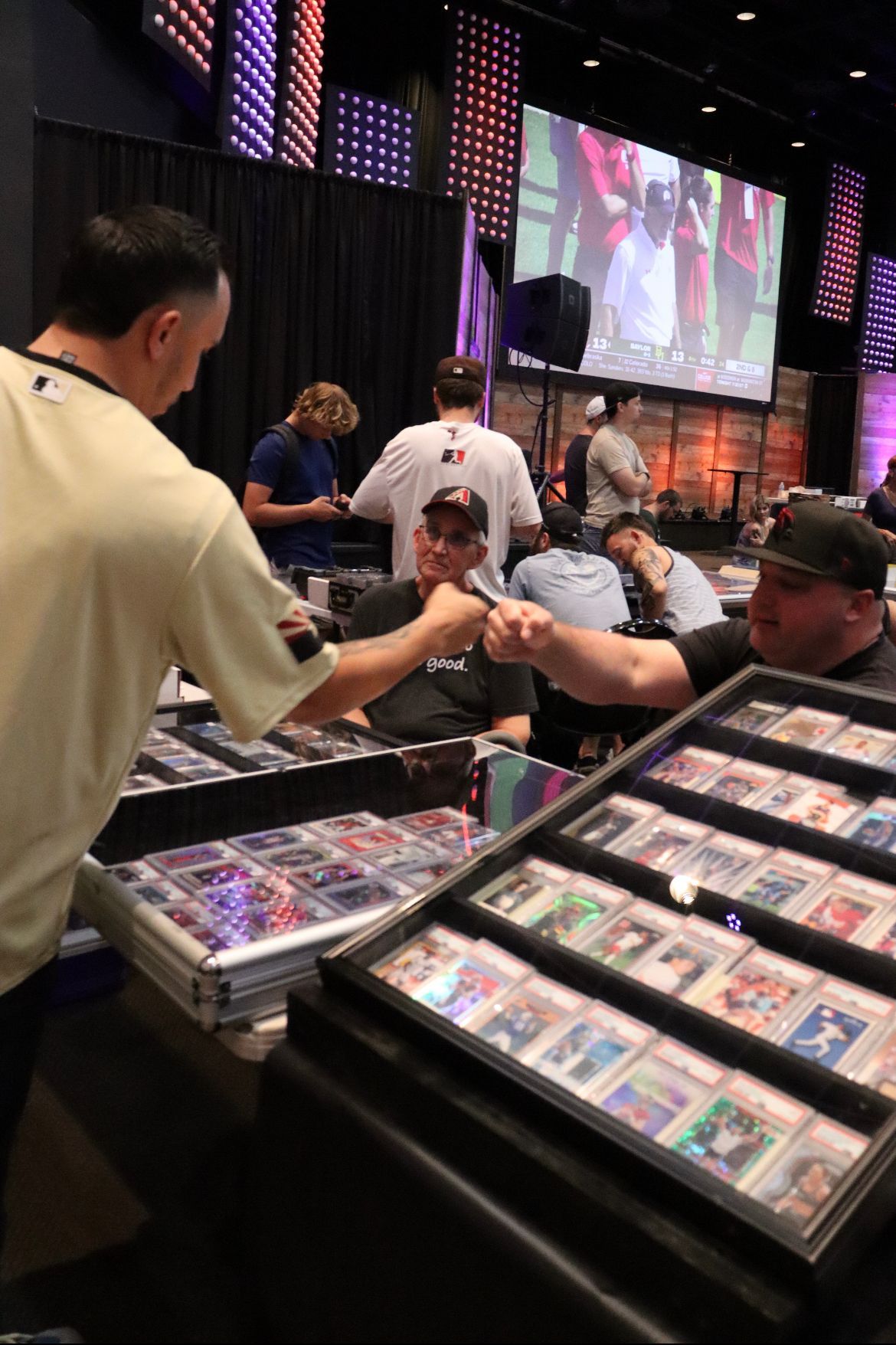 A man is standing in front of a display of baseball cards.