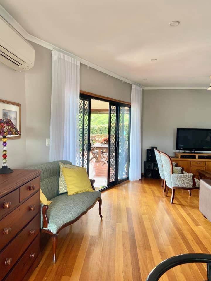 A Living Room With a Couch, Chairs, Dresser and Television — Whitsunday Vogue Interiors in Bowen, QLD