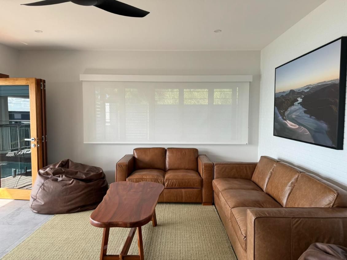 A Living Room With Two Couches, a Coffee Table, and a Ceiling Fan — Whitsunday Vogue Interiors in Cannonvale, QLD