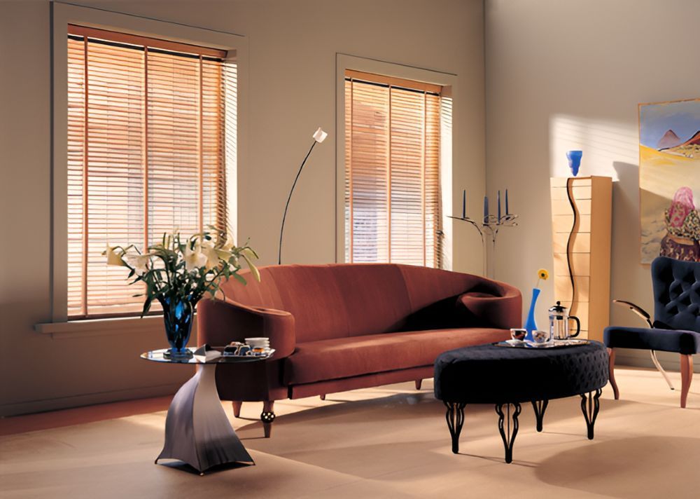 A Living Room With a Red Couch and a Black Ottoman — Whitsunday Vogue Interiors in Bowen, QLD