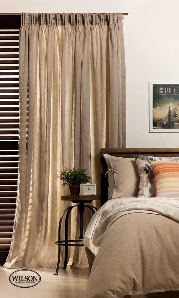 A Bedroom With a Bed, Nightstand, and Curtains — Whitsunday Vogue Interiors in Cannonvale, QLD