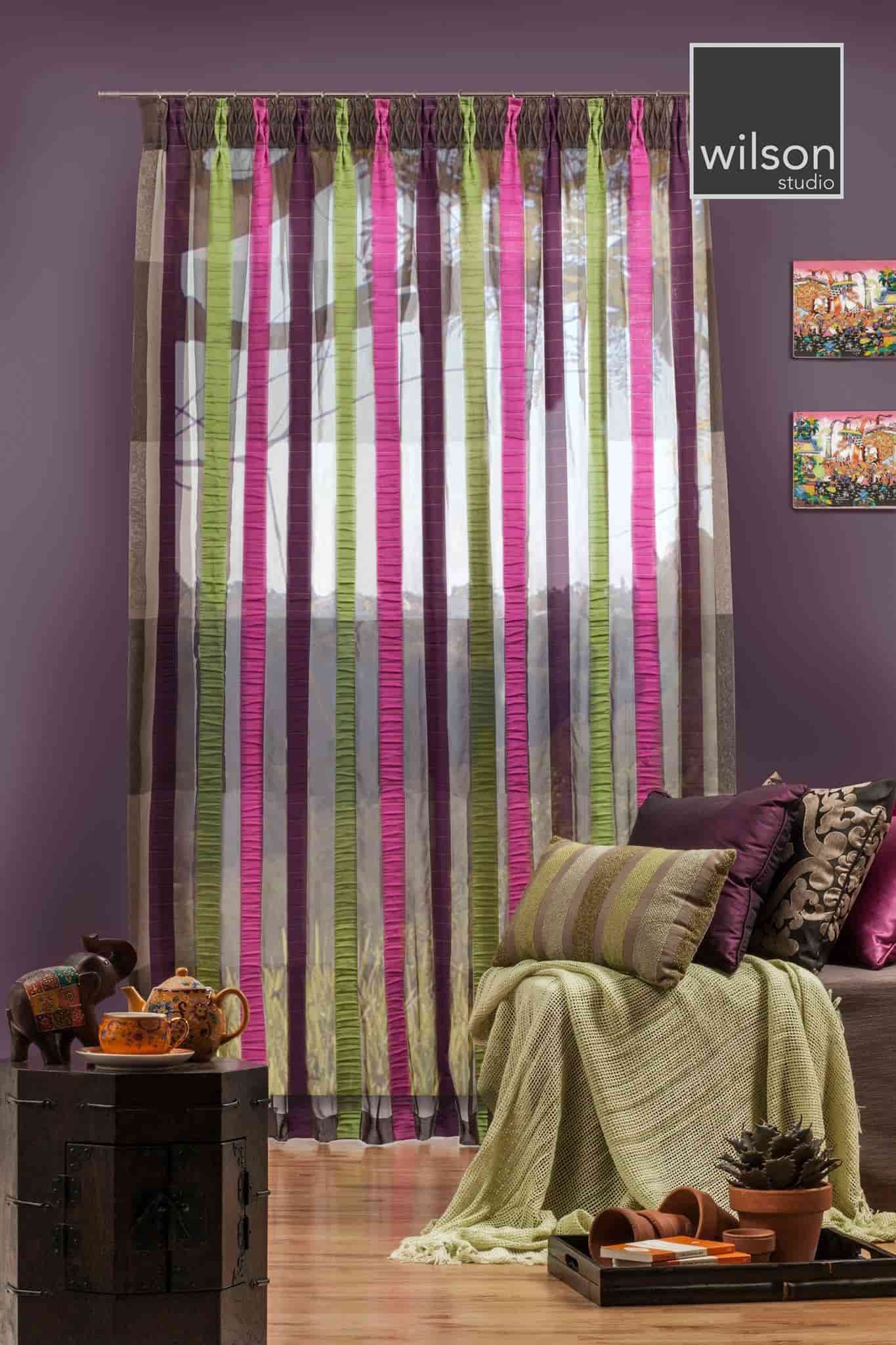 A Living Room With Purple Walls and Colorful Curtains — Whitsunday Vogue Interiors in Cannonvale, QLD