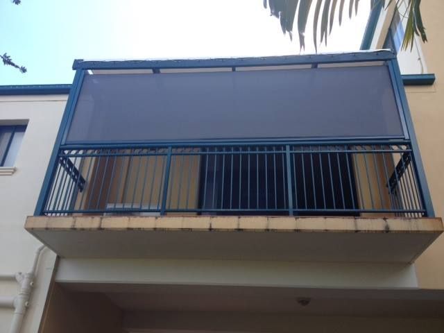 A Balcony With a Blue Railing and a Gray Screen — Whitsunday Vogue Interiors in Cannonvale, QLD