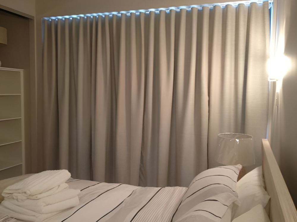 A Bedroom With a Bed and a Window With White Curtains — Whitsunday Vogue Interiors in Proserpine, QLD