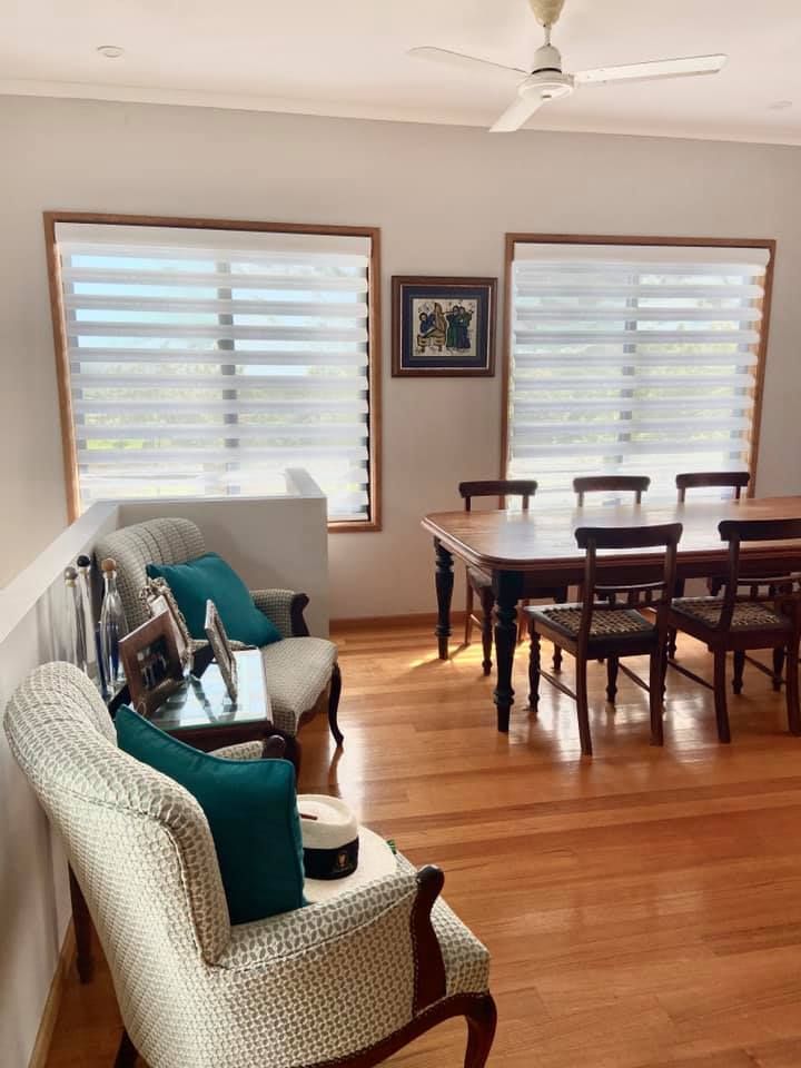 A Living Room With a Table and Chairs and a Ceiling Fan — Whitsunday Vogue Interiors in Cannonvale, QLD