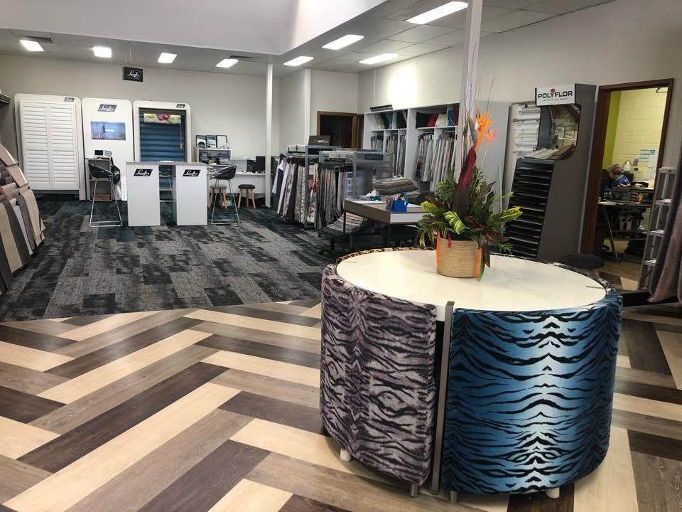 Showroom With Patterned Floors, Fabric Samples, and a Display Table — Whitsunday Vogue Interiors in Cannonvale, QLD