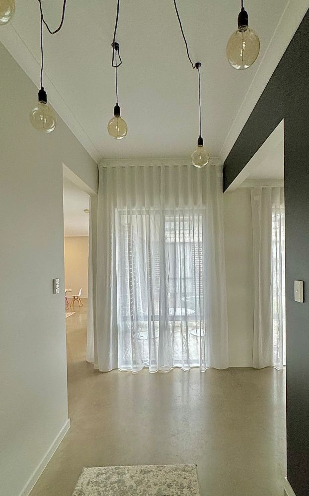 There Are a Lot of Lights Hanging From the Ceiling in This Hallway — Whitsunday Vogue Interiors in Cannonvale, QLD