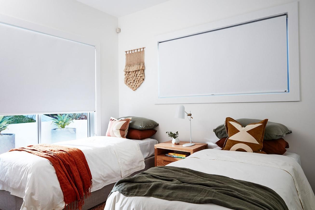 There is a Large White Wall in the Backyard With a Pool in the Background — Whitsunday Vogue Interiors in Cannonvale, QLD