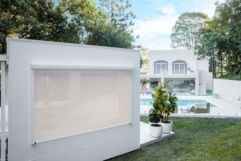A Bedroom With a Bed, Nightstand, Lamps and a Chandelier — Whitsunday Vogue Interiors in Cannonvale, QLD
