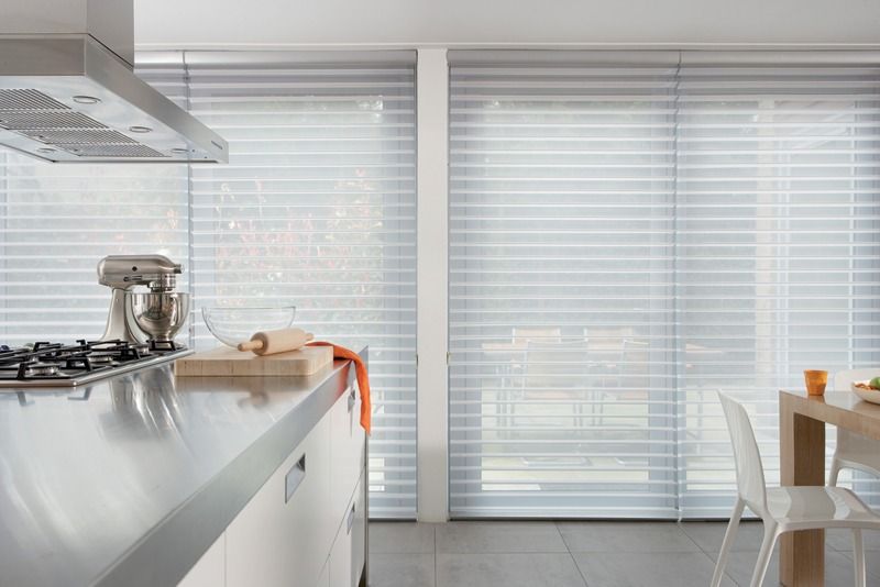 Modern Kitchen With White Countertops, Gas Stove, and Sheer Horizontal Blinds — Whitsunday Vogue Interiors in Cannonvale, QLD