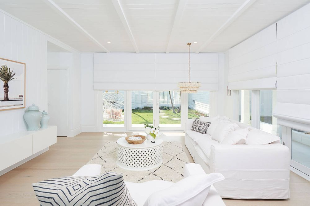 A Living Room With White Furniture, a Couch, a Table, and a Picture on the Wall — Whitsunday Vogue Interiors in Airlie Beach, QLD