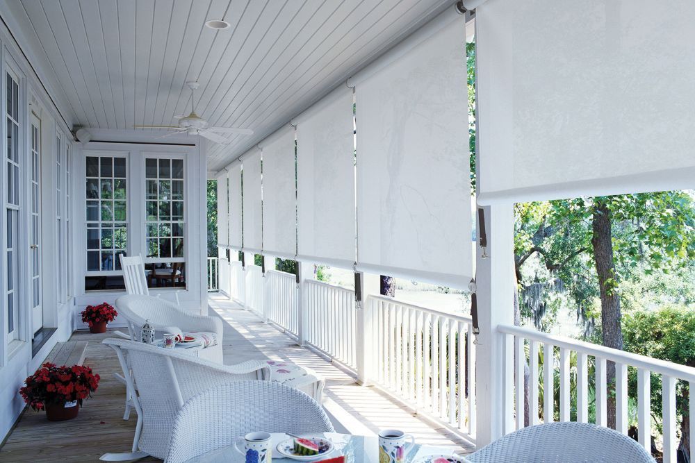 A Porch With a Table and Chairs and White Blinds — Whitsunday Vogue Interiors in Hamilton Island, QLD