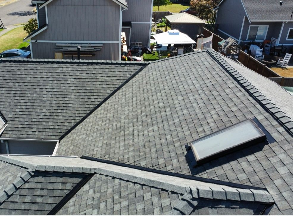 An aerial view of a roof with a skylight on it.