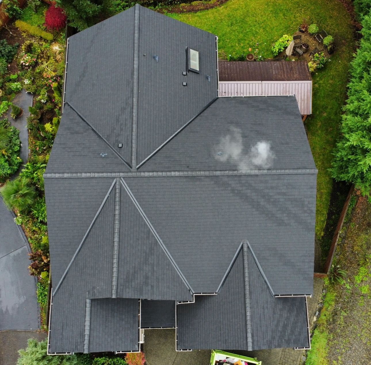 An aerial view of a house with a black roof