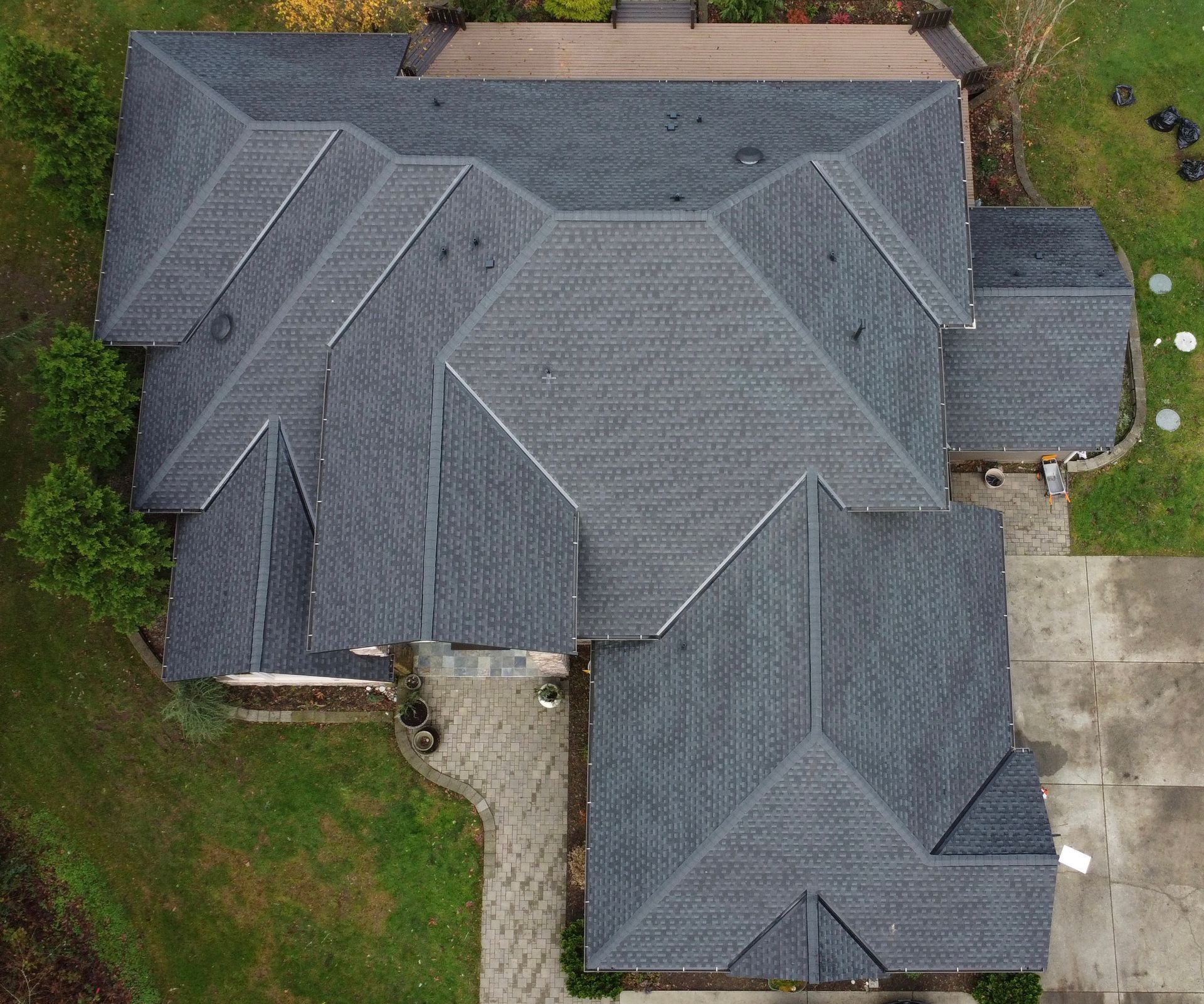 An aerial view of a large house with a gray roof.